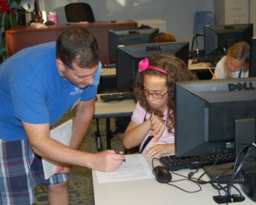Child at computer with Staff member