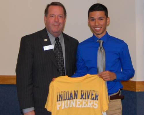 Student holding up Indian River Pioneers shirt