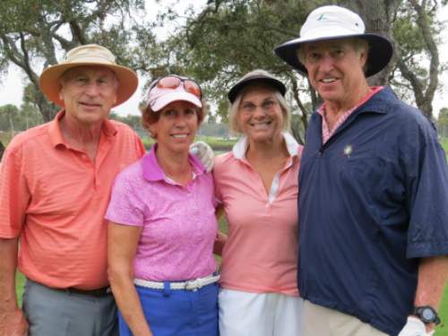 Four adults at golf tournament