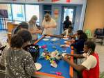 Teens making cat toys for the Humane Society