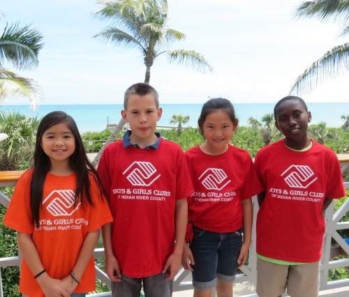 Four BGCIRC students outside in front of palm trees