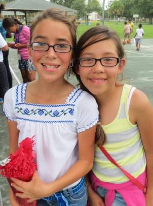 Two young ladies with glasses smiling